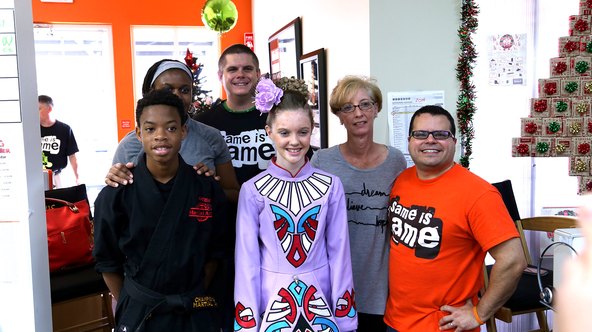 Young grant recipients, a martial artist and an Irish dancer, with Jimmy Vee and supporters